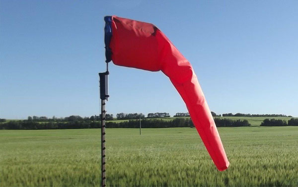 Red windsock in green field